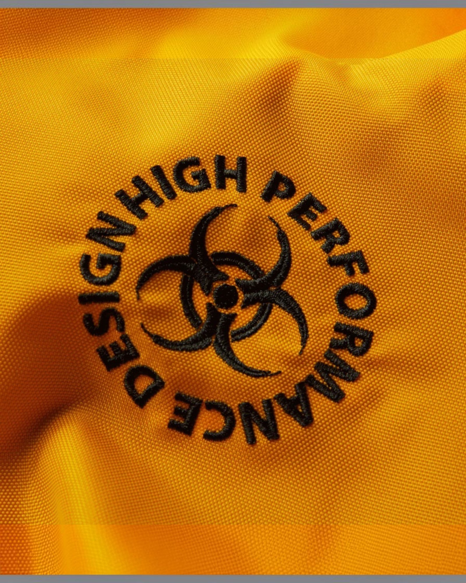 HUF Sector Jacket in black and yellow with embroidered "DESIGN HIGH PERFORMANCE" circular logo.