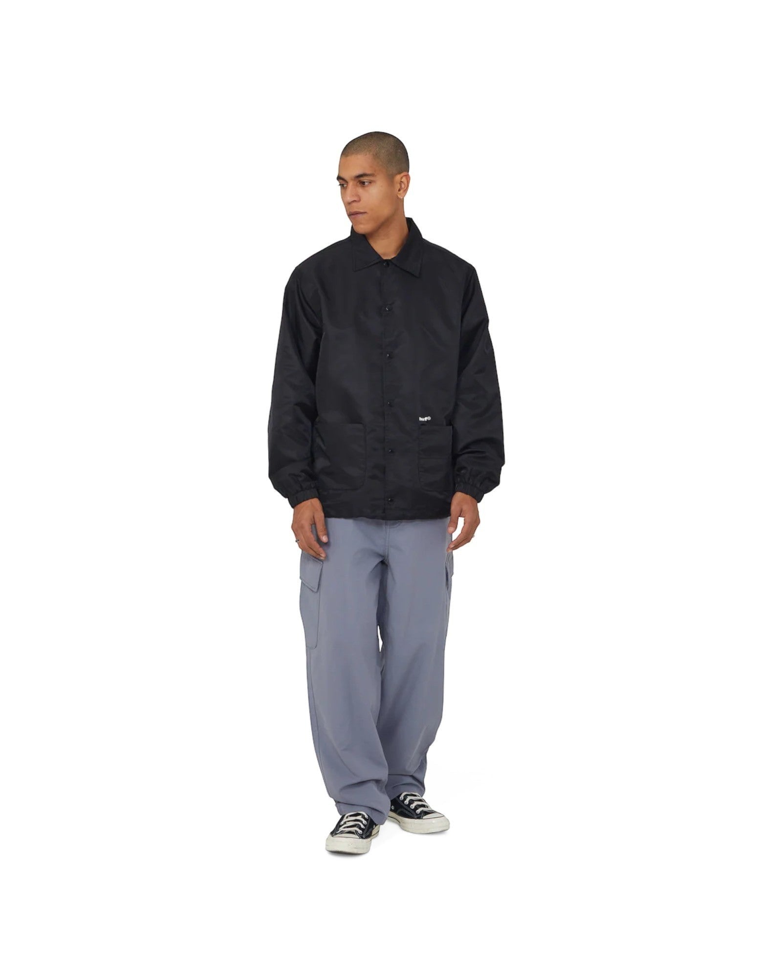 impostor.ro blue baggy cargo pants with side pockets and a relaxed fit, worn by a male model.